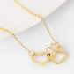 Collar de acero en color dorado con colgante de huella  y corazón