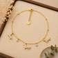 Pulsera de acero inoxidable dorada con perro y circonitas