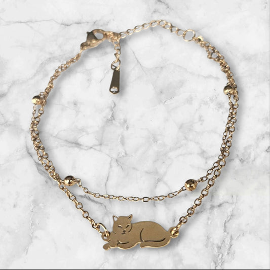 Pulsera de acero doble en color dorado con gato y bolitas