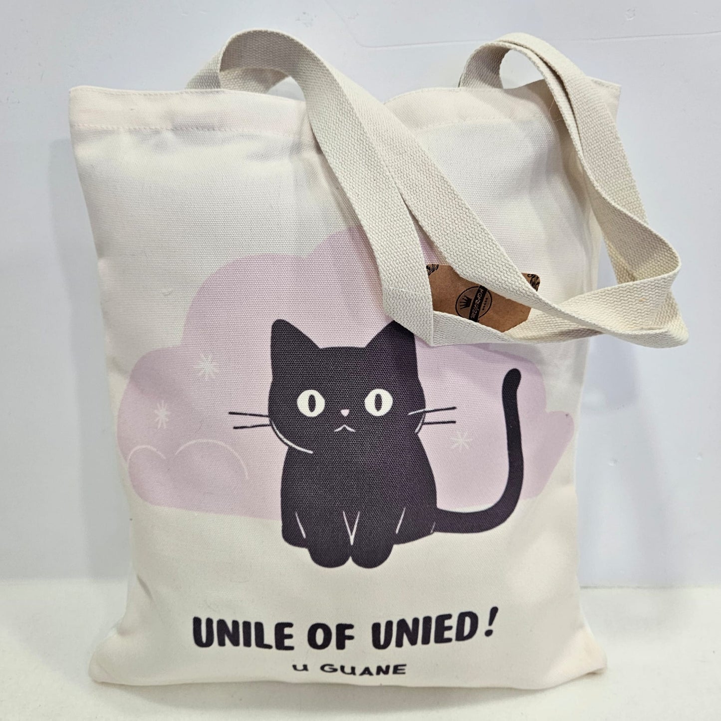 Bolsa tote bag de tela estampado gatito con frase "UNILE OF UNIED!"